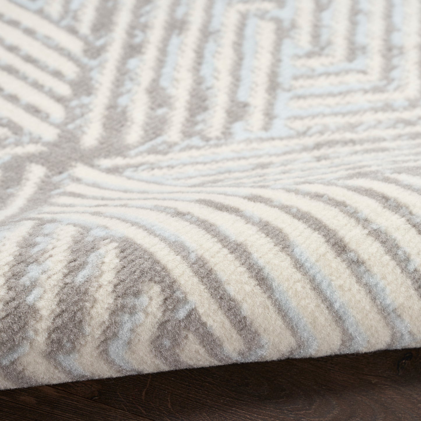 Beige and ivory geometric round rug with plush pile and raised stripe pattern; modern home decor.
