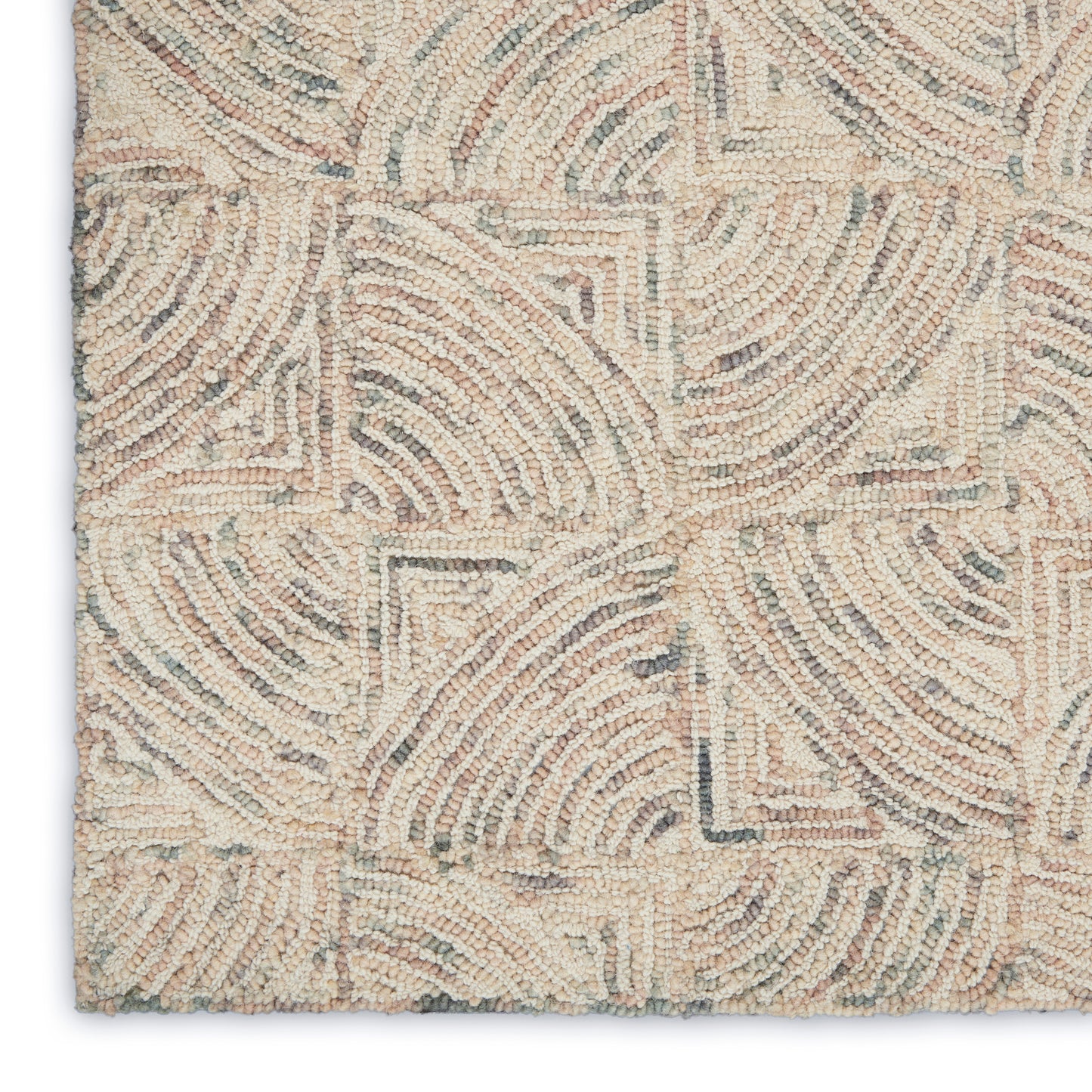 Beige tufted rug with cream and taupe geometric arc pattern, textured loop pile for modern/coastal decor.