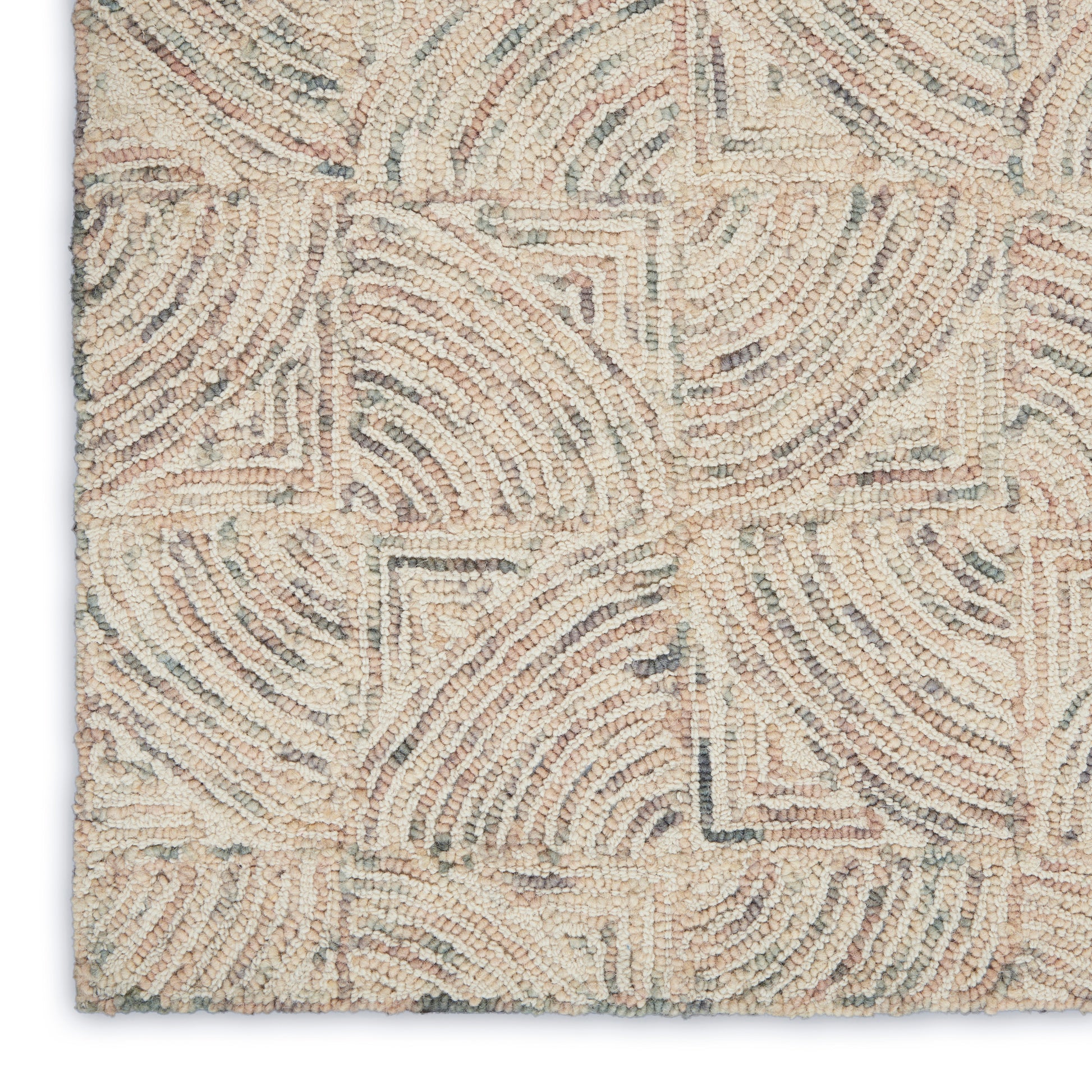 Beige tufted rug with cream and taupe geometric arc pattern, textured loop pile for modern/coastal decor.