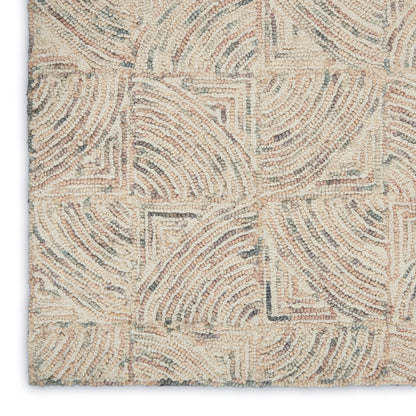 Beige tufted rug with cream and taupe geometric arc pattern, textured loop pile for modern/coastal decor.