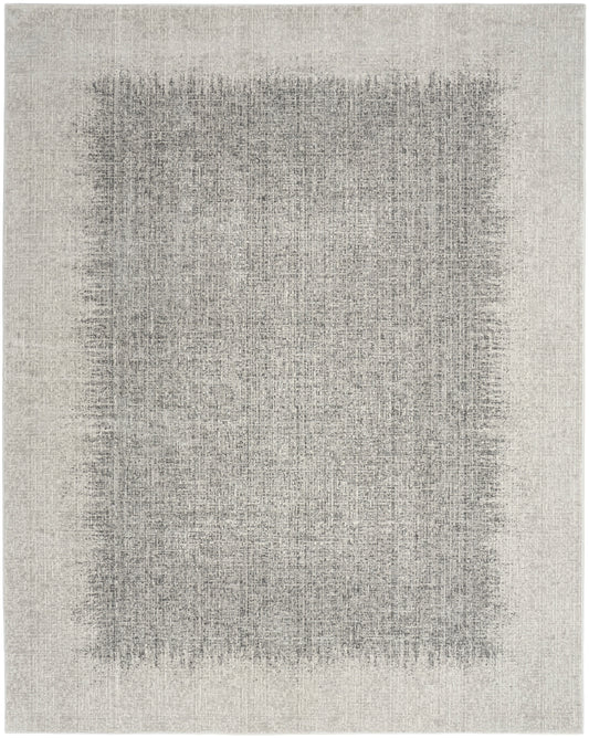Neutral beige-gray rug with a large softly faded dark rectangle in the center, modern distressed look.