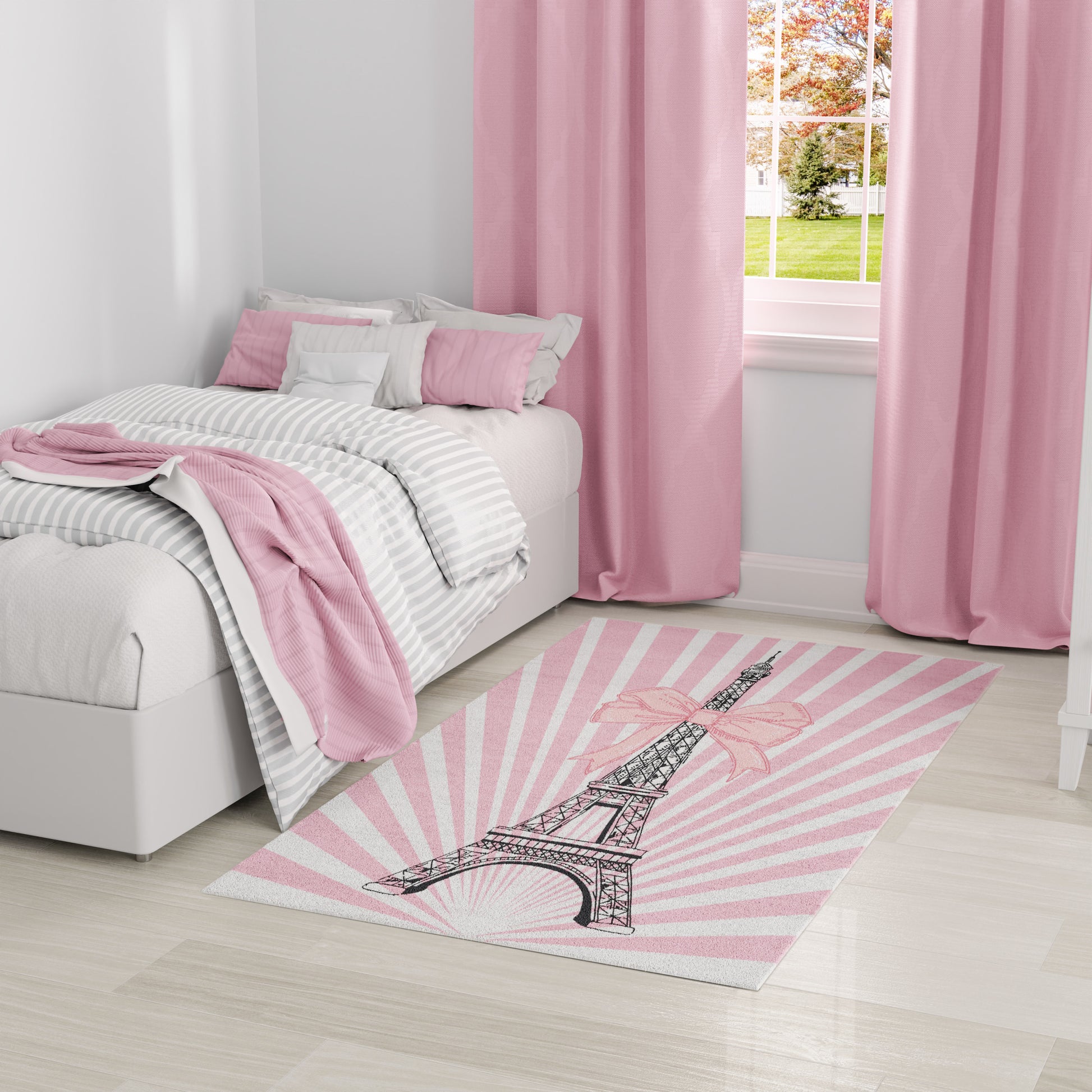 Pink-themed bedroom with white bed, grey striped bedding, pink throw and cushions; pink curtains; Eiffel Tower rug.