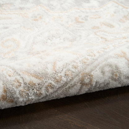 Rectangular plush cream rug with beige geometric pattern, thick pile, edge folded on dark wood floor.
