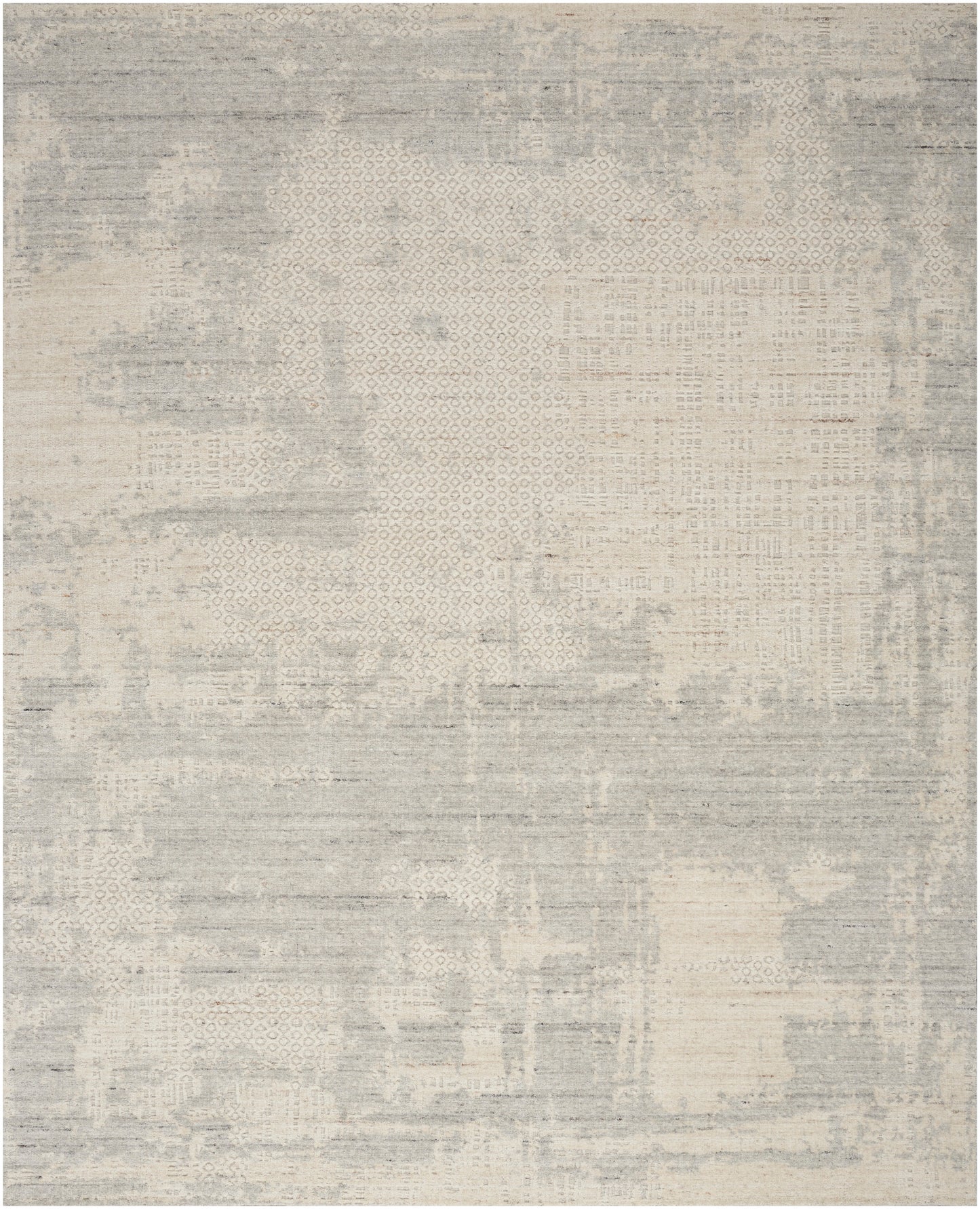 Neutral grey-beige distressed area rug with patchwork texture and subtle geometric patterns.