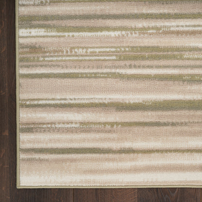 Woven area rug with beige, cream, taupe and sage horizontal stripes on dark wood floor.