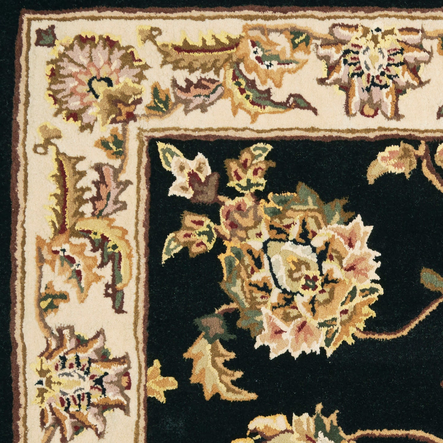 Ornate floral rug with cream border and black field; pink, gold, and green flowers in a Persian-inspired design.
