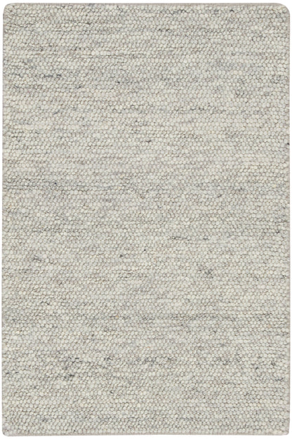 Beige speckled loop-pile rug with gray undertones; rectangular with rounded corners, cozy neutral decor.