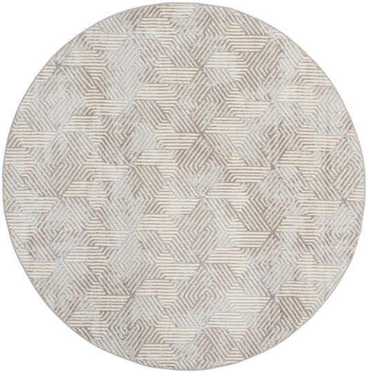 Round rug in beige, taupe and gray with interlocking striped hexagon pattern; softly textured, contemporary decor