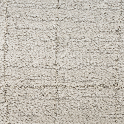 Cream shag rug with plush boucle texture and subtle square-grid pattern in beige tones.
