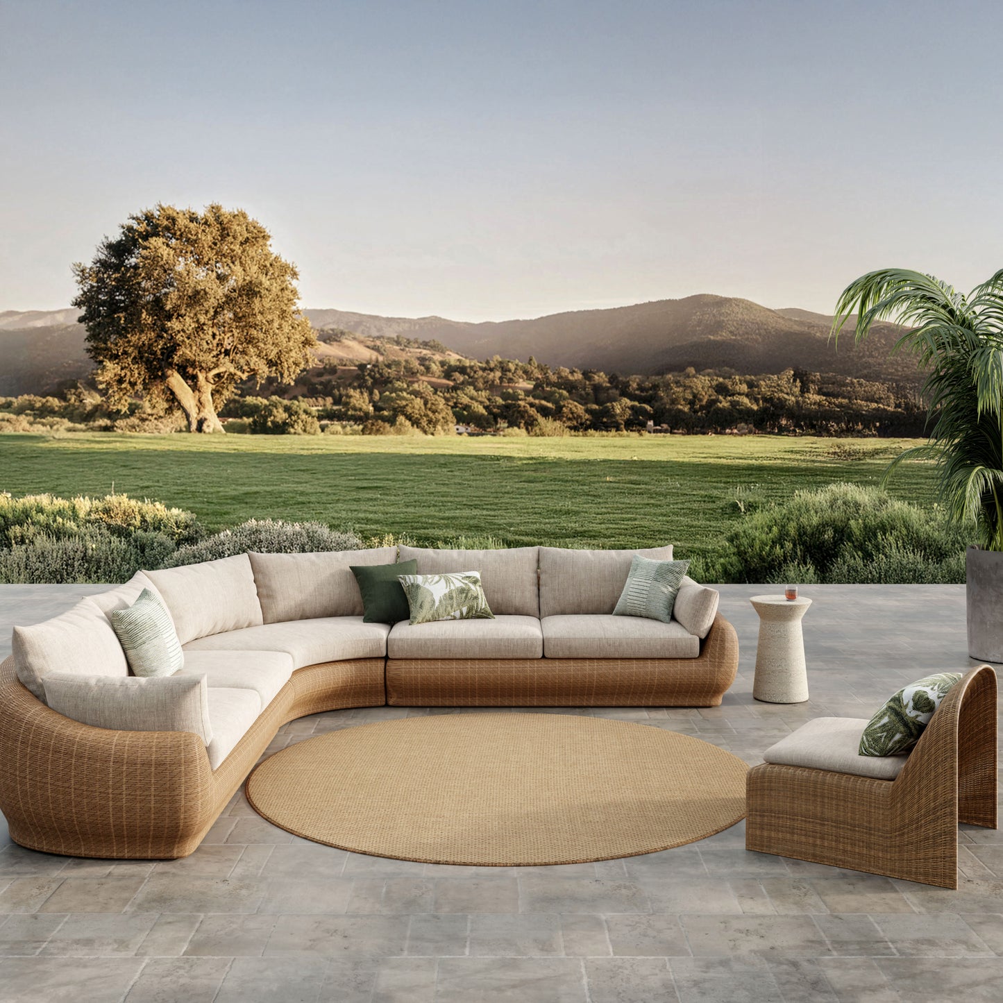 Circular outdoor rug on a stone patio with a scenic countryside backdrop.