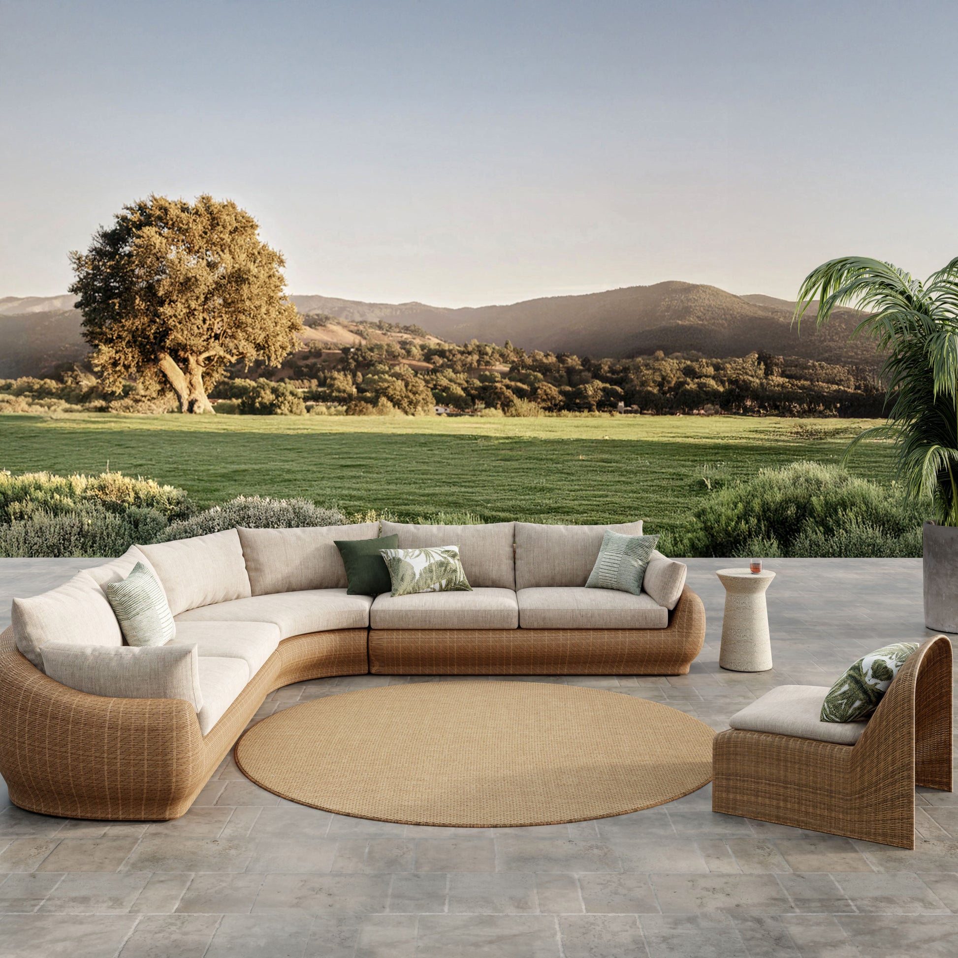 Circular outdoor rug on a stone patio with a scenic countryside backdrop.