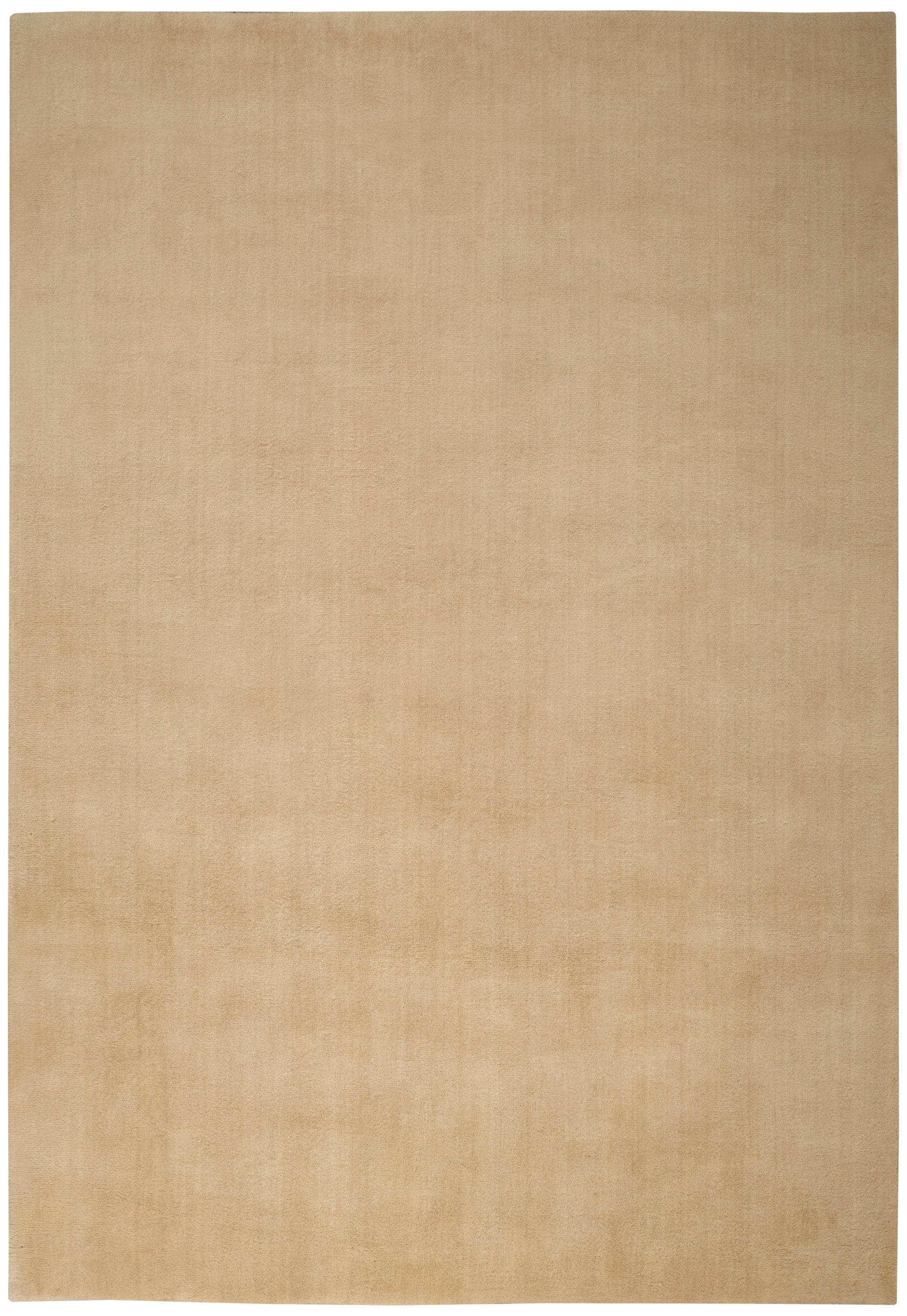 Light tan rectangular rug with subtle texture and soft, matte finish.