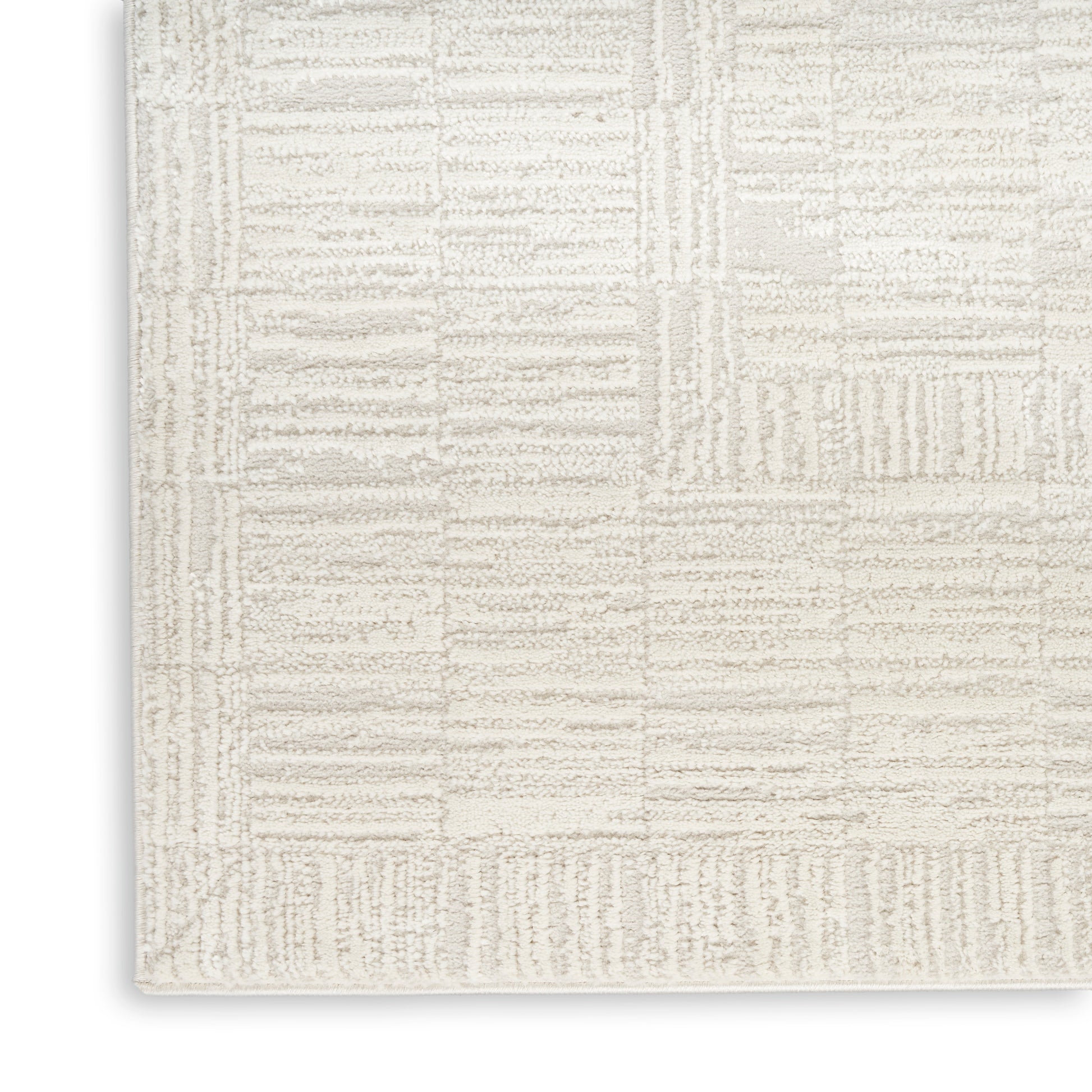 Cream textured area rug with beige geometric patchwork blocks; plush, modern living-room rug.