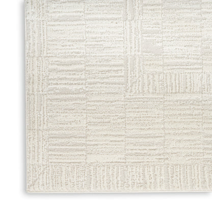 Cream textured area rug with beige geometric patchwork blocks; plush, modern living-room rug.