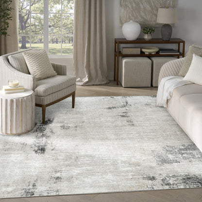 Neutral living room with cream sofa and armchair, textured rug, wooden console, round side table, and beige curtains.