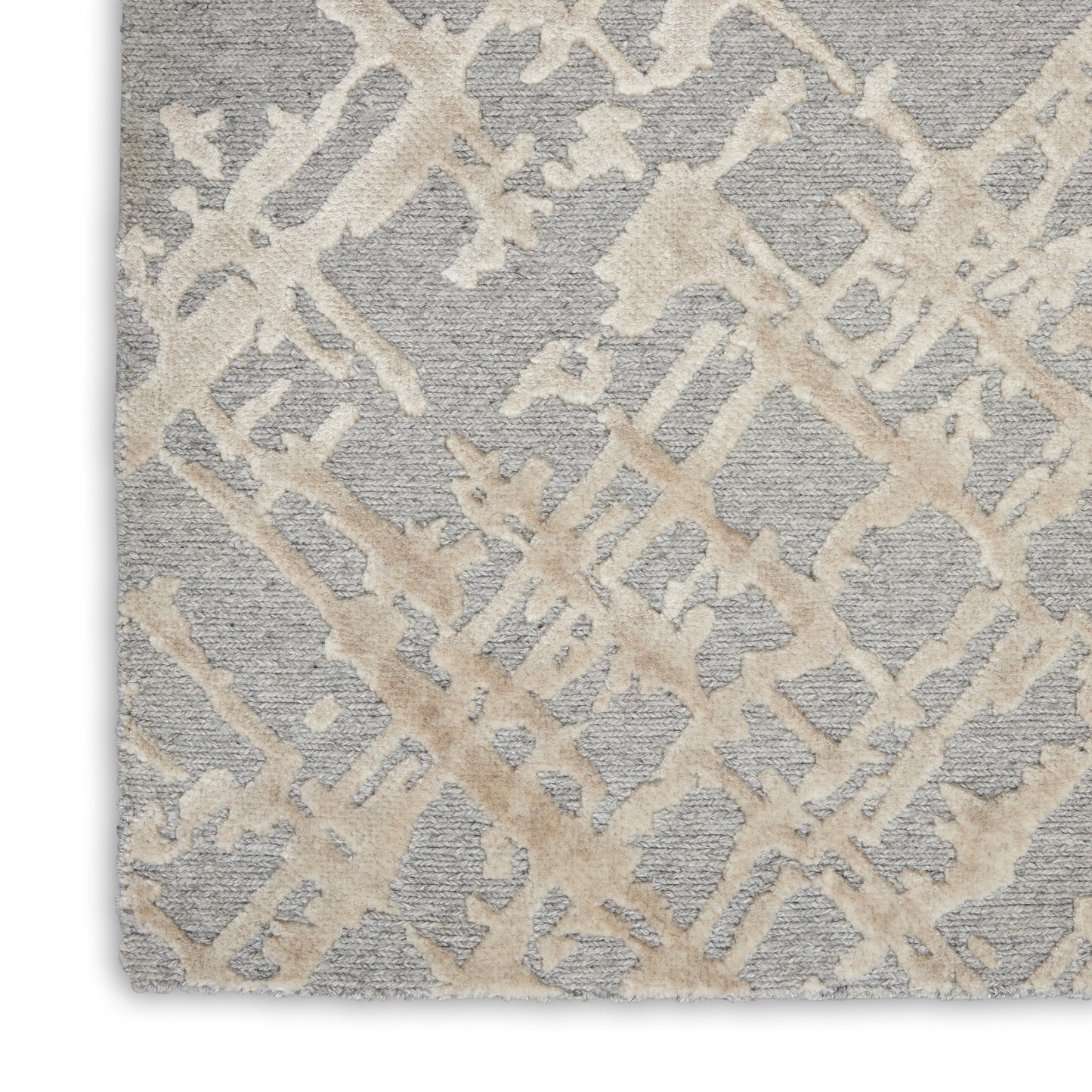 Soft gray textured rug with beige abstract lattice pattern; modern geometric style for living room.