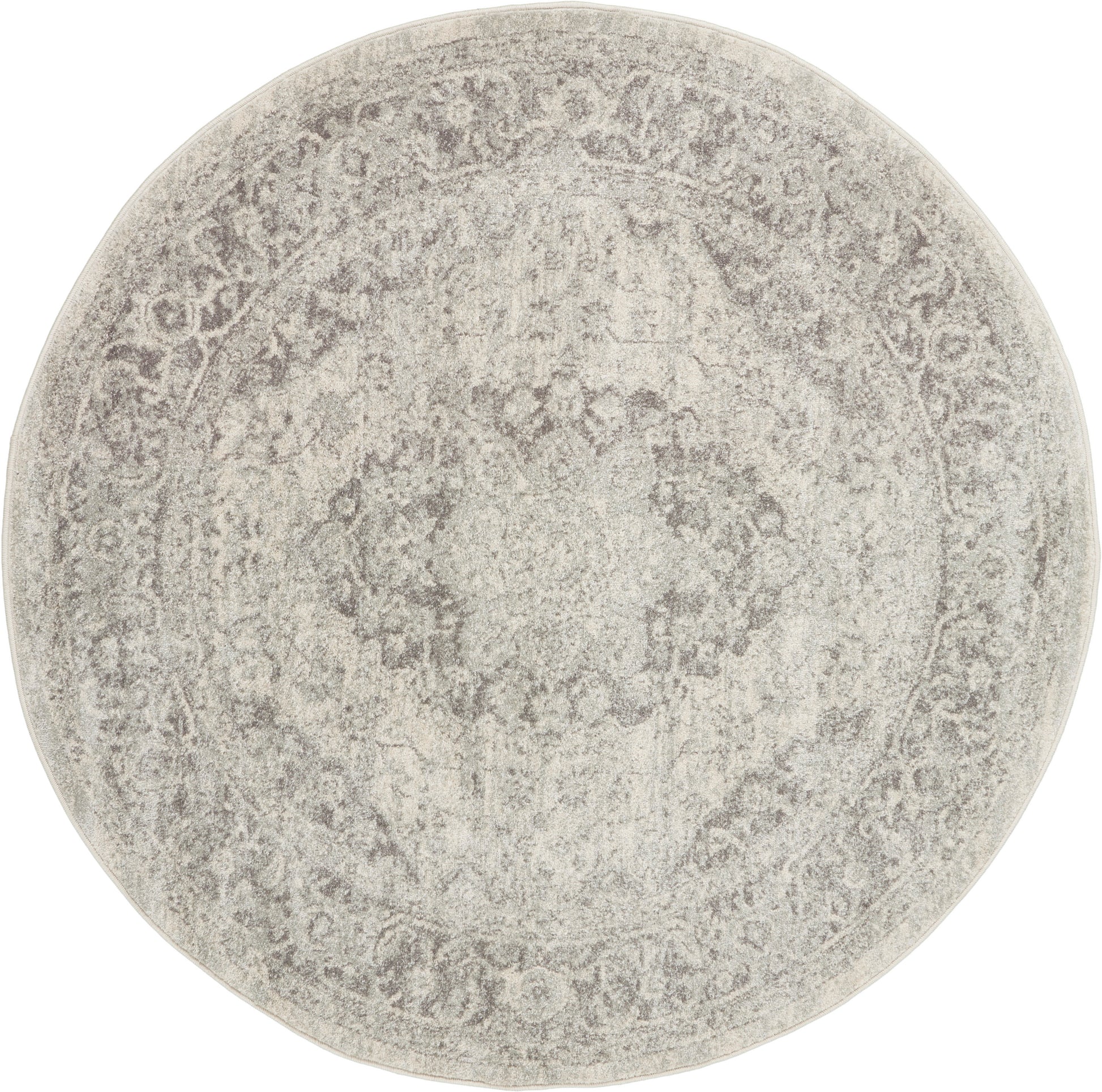 Round distressed beige-gray oriental rug with a faded central medallion and decorative border.