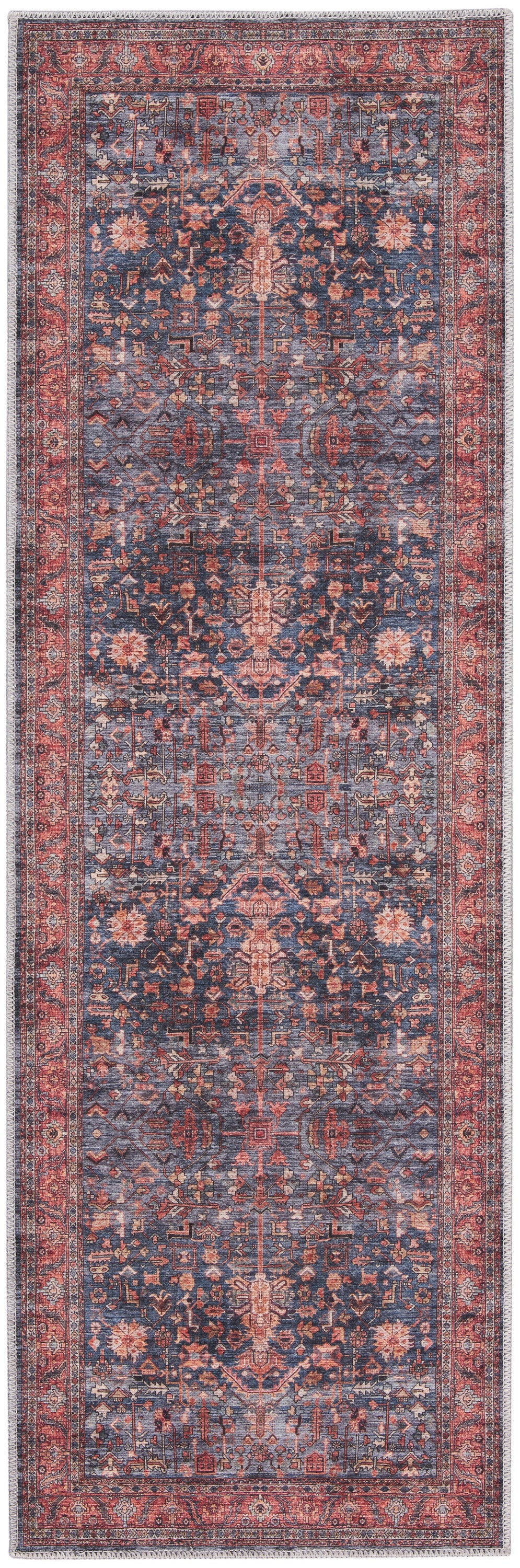 Persian-style runner rug in blue and red with intricate floral motifs and fringed ends.