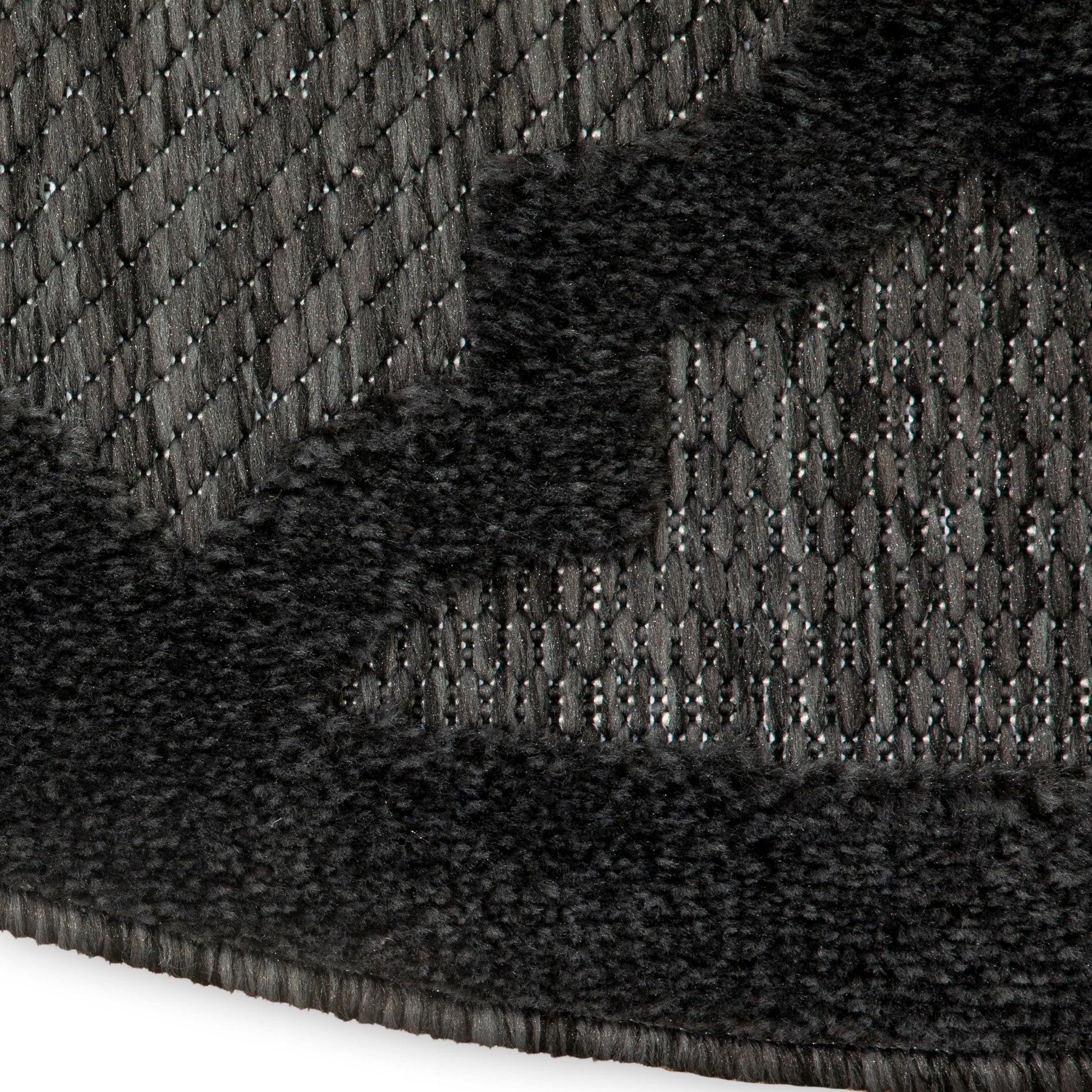Charcoal woven rug with plush black faux fur border, modern textured design for living room or bedroom.