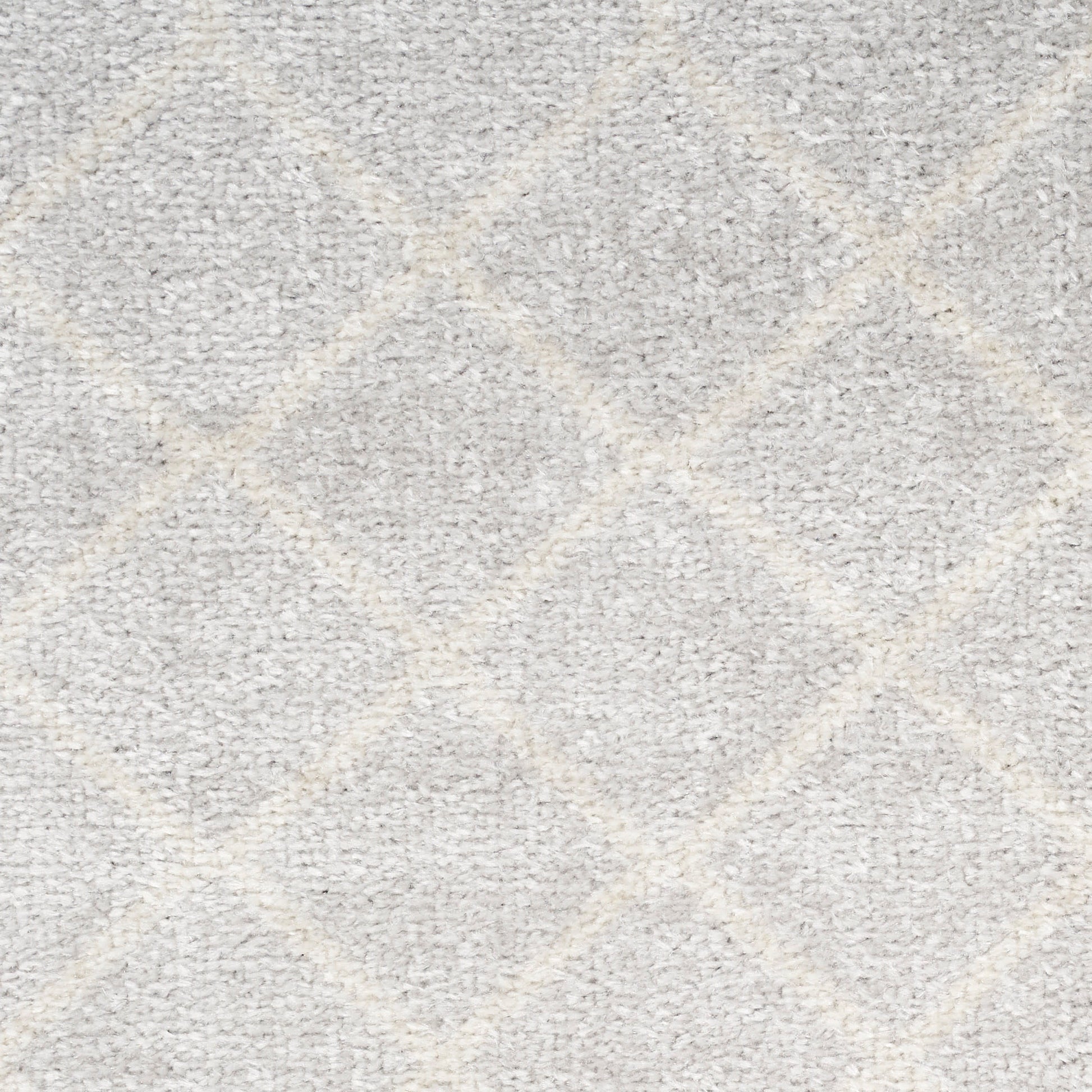 Light gray shag rug with cream diamond lattice pattern; plush, soft texture for living spaces.