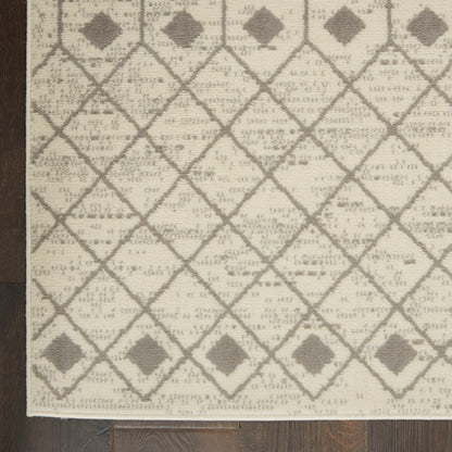 Beige woven rug with gray diamond lattice pattern, small diamonds at intersections, light fringe along edge.