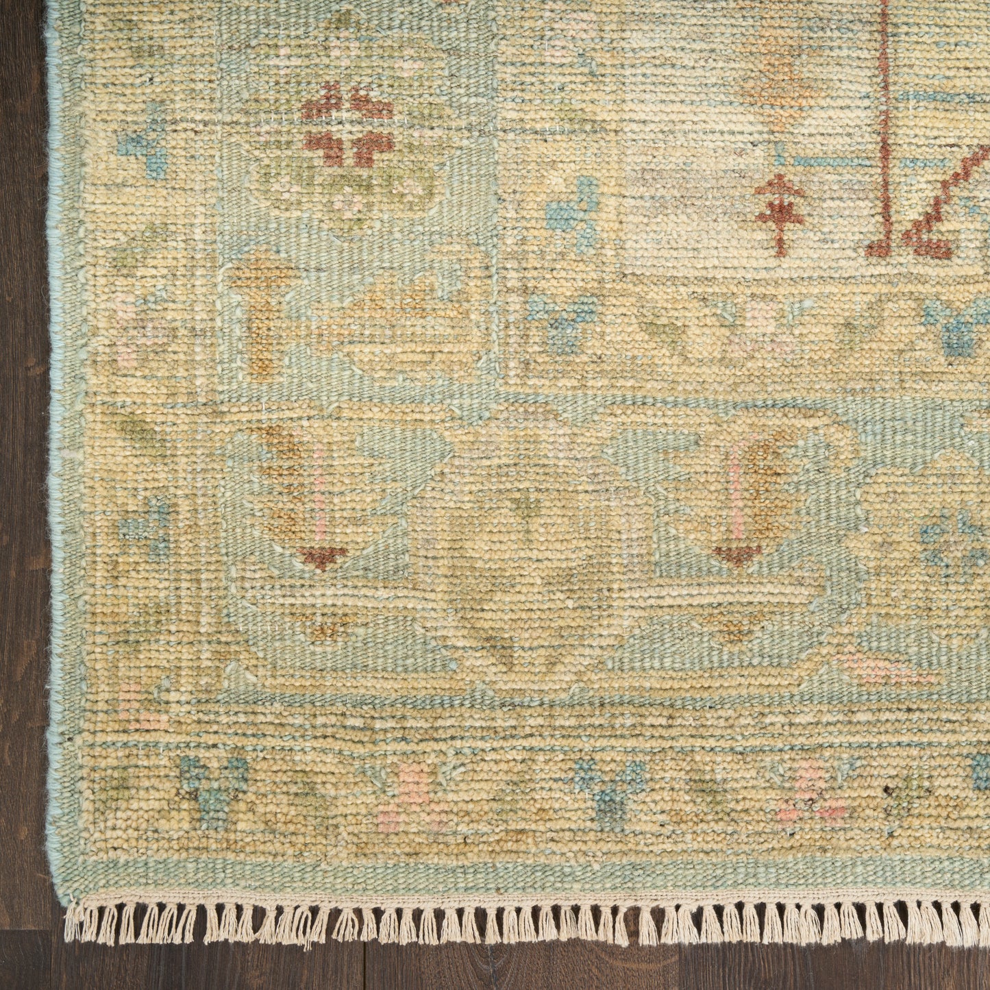 Pastel wool rug with fringe edge, beige and light blue tones, oriental floral pattern; decorative floor mat.