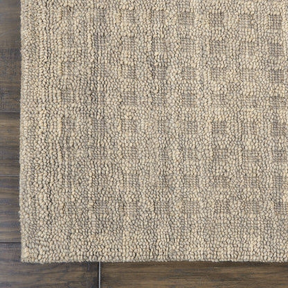 Beige boucle runner rug with dense loop-pile texture and subtle geometric pattern on dark wooden floor.