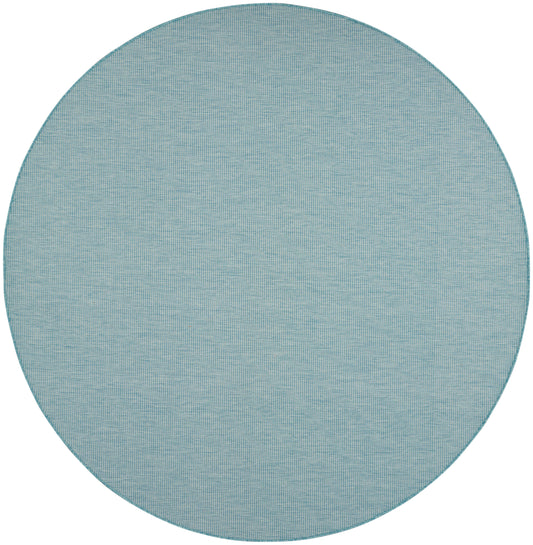 Round teal-blue woven rug with fine grid texture and stitched edge.