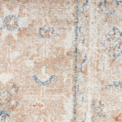 Beige-pink oriental rug close-up with blue floral motifs and subtle borders.