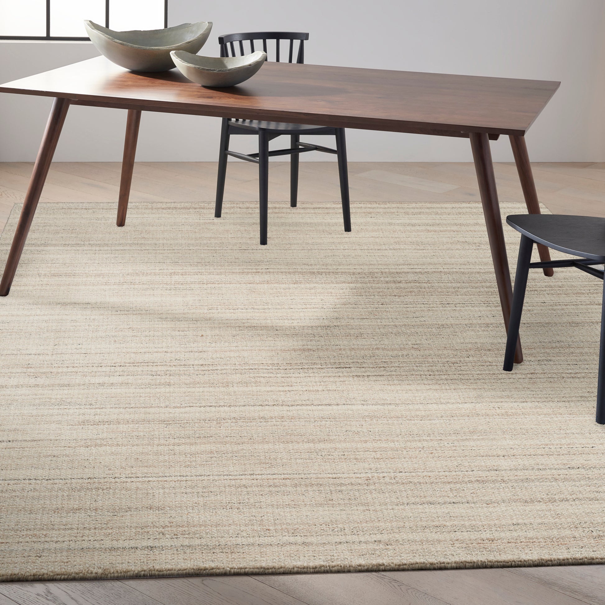 Modern 9' x 12' rug in beige/neutral tones laid on a floor.