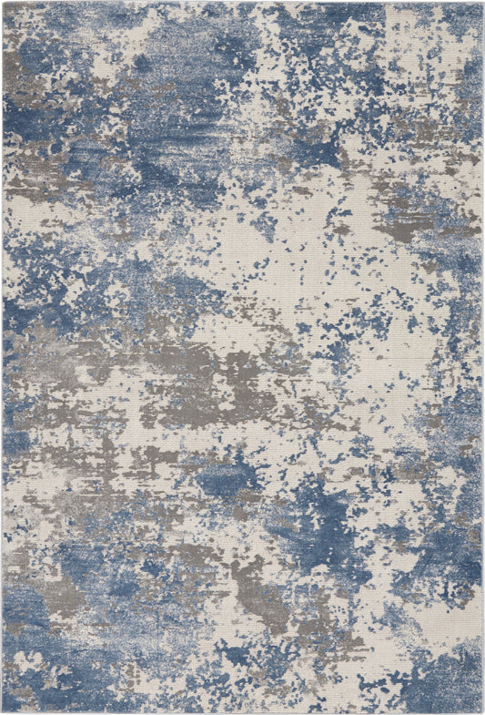 Rectangular abstract area rug with blue and taupe splatters on beige; modern contemporary home decor.
