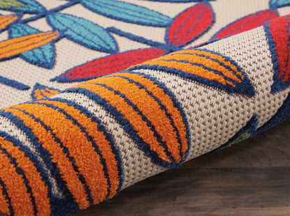 Vibrant woven rug with orange stripes and blue leaf motifs on beige background, rolled on wood floor, tropical 3' x 4'.