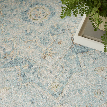 Blue and cream patterned area rug with a floral medallion motif.