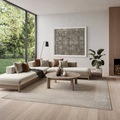 Neutral living room with beige rug (8' x 10'), round wood coffee table, large abstract art, and a floor lamp by tall windows.