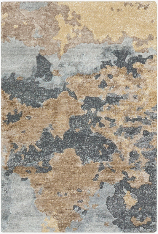 Abstract area rug with beige, tan, blue-gray and charcoal patches in a modern camouflage pattern.