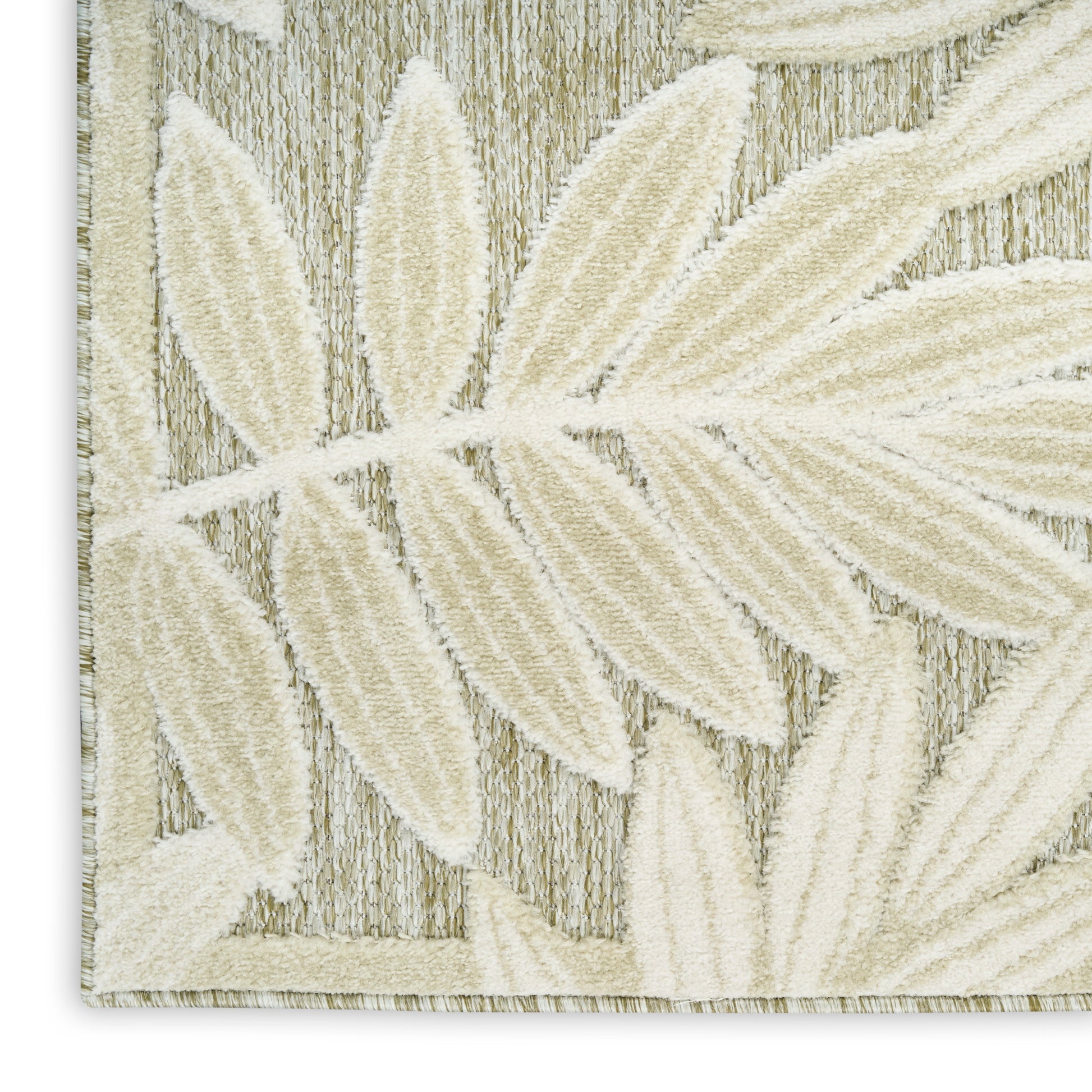 Cream textured rug with embossed palm-leaf pattern and light border, woven in beige fibers.