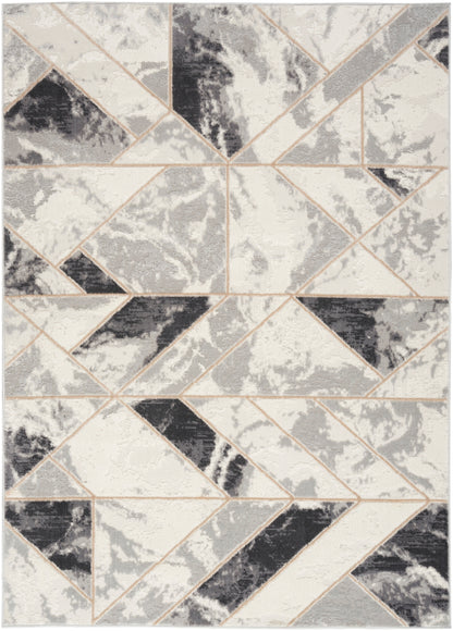 Tessellated geometric rug with ivory, gray, and black triangles and beige outlines; modern abstract living-room accent.
