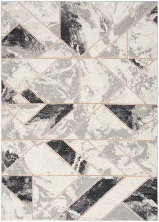 Tessellated geometric rug with ivory, gray, and black triangles and beige outlines; modern abstract living-room accent.