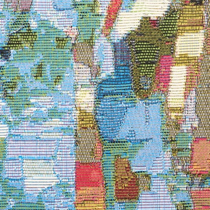 Close-up of multicolor woven rug with abstract patchwork in blues, greens, yellows, reds and pinks.