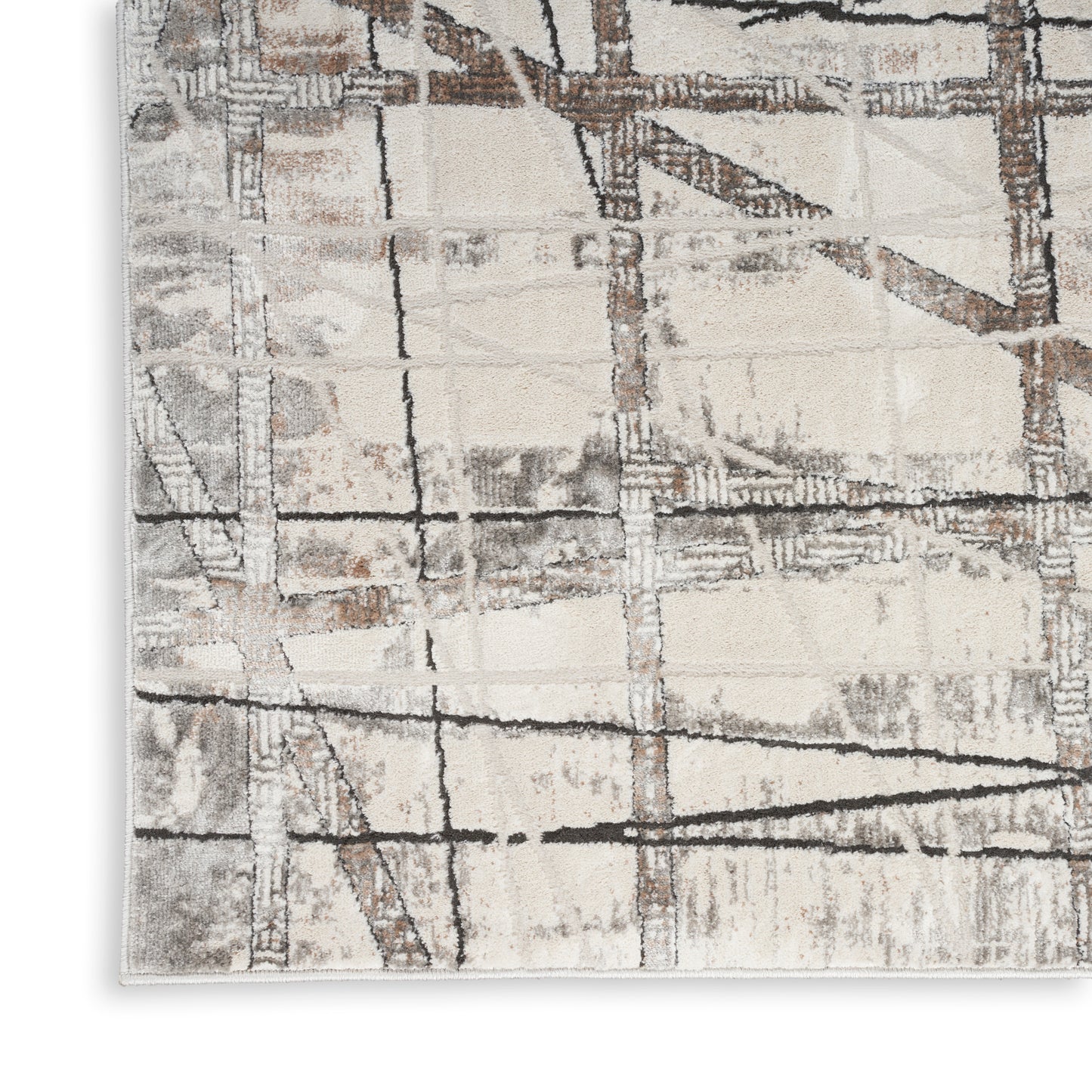 Abstract beige and gray area rug with brown-black linear grid pattern; distressed, modern style.