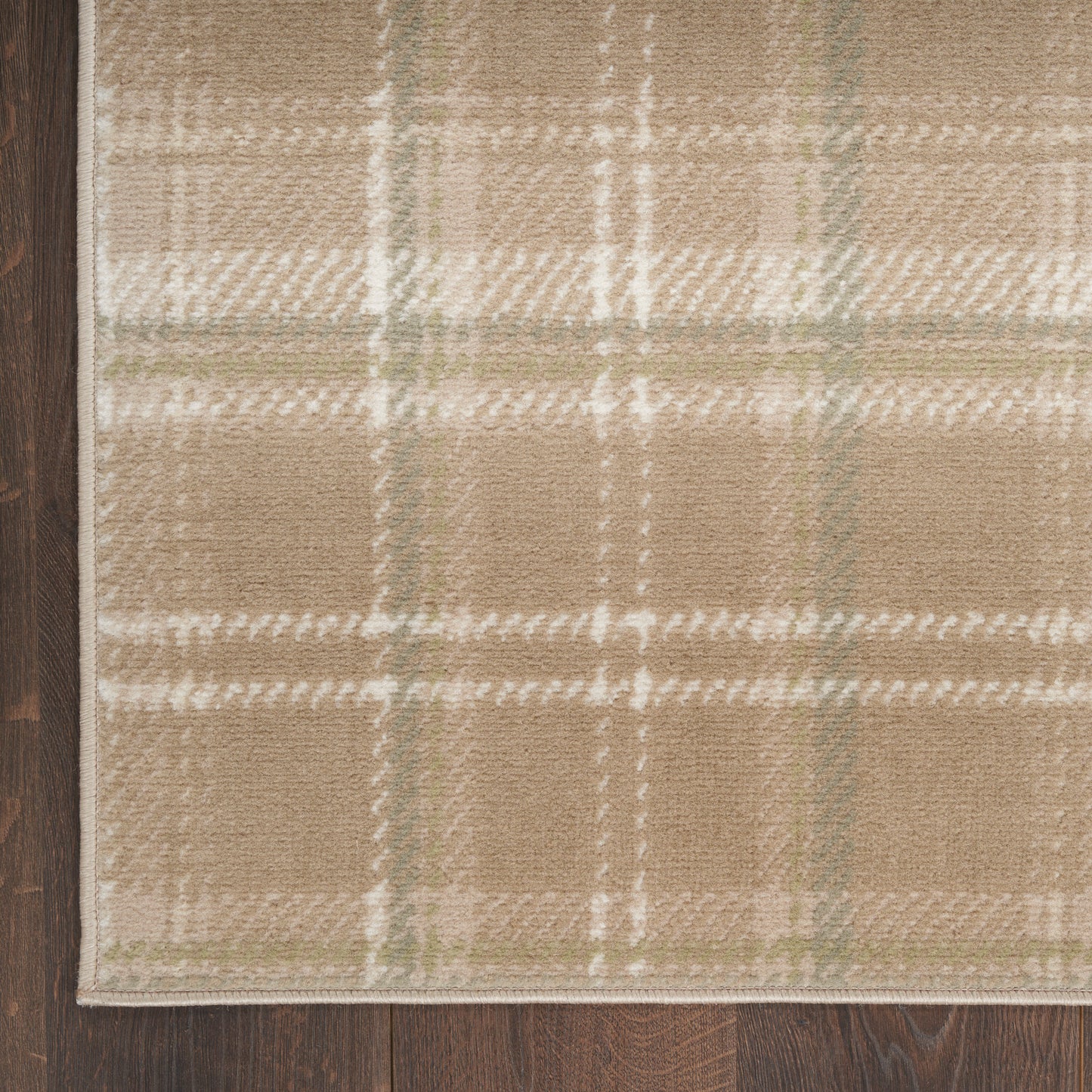 Beige plaid rug with white & pale green lines, soft textured weave, rectangular; cozy living room rug on dark wood floor.