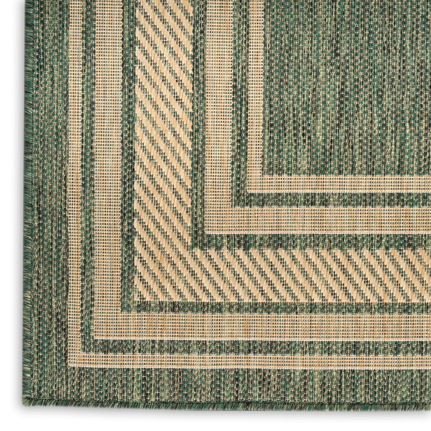 Green and natural beige flatwoven rug with concentric rectangular borders and diagonal striped textures; rustic geometric style.