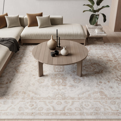 Beige patterned rug in a neutral Scandinavian living room with sofa cushions.