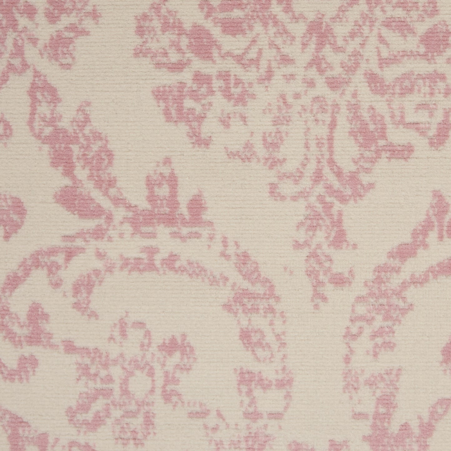 Cream background with pink damask pattern on a vintage rug.