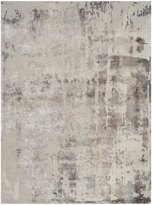 Abstract neutral area rug in beige, taupe and gray with distressed pattern; modern floor decor.