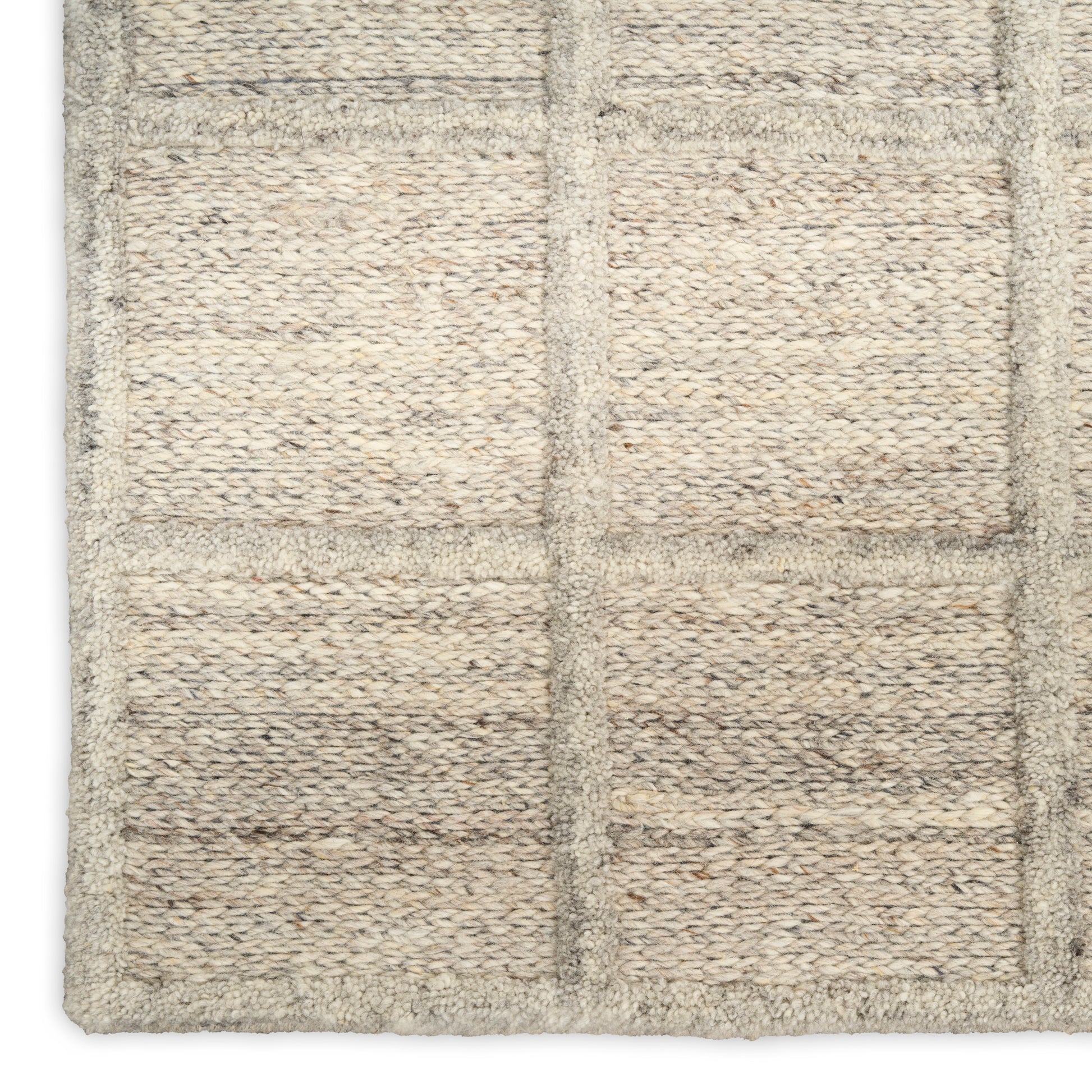 Natural beige woven rug with a chunky loop texture and a subtle grid of rectangular panels.