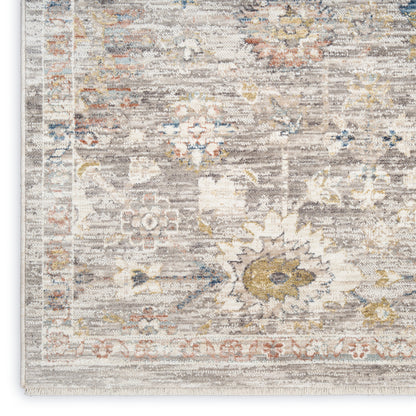 Distressed oriental runner in muted ivory, gray, blue, and yellow with floral medallions and fringed border.