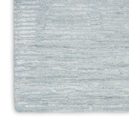 Soft light blue textured area rug with subtle horizontal striations; modern coastal decor.