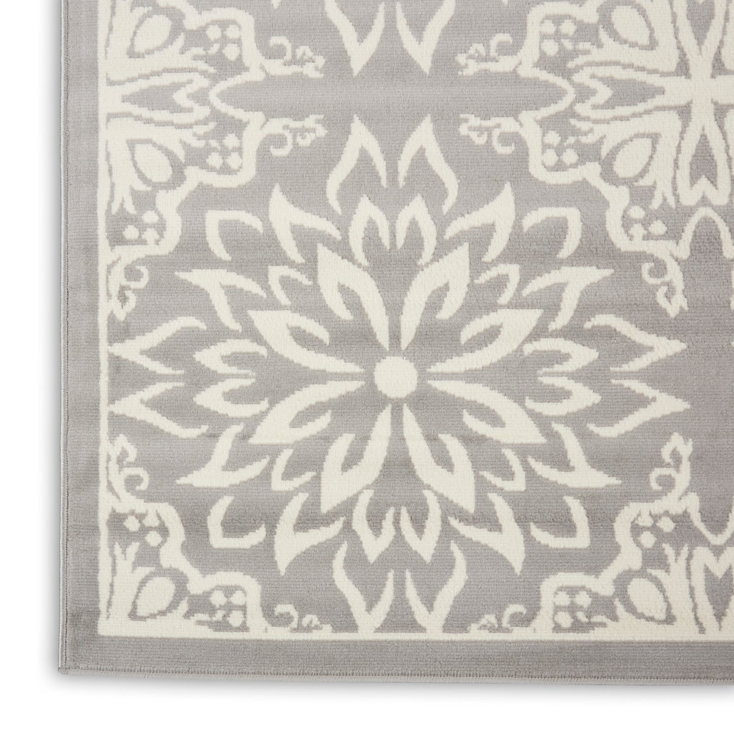 Gray area rug with a large ivory mandala medallion and light border, decorative pattern.