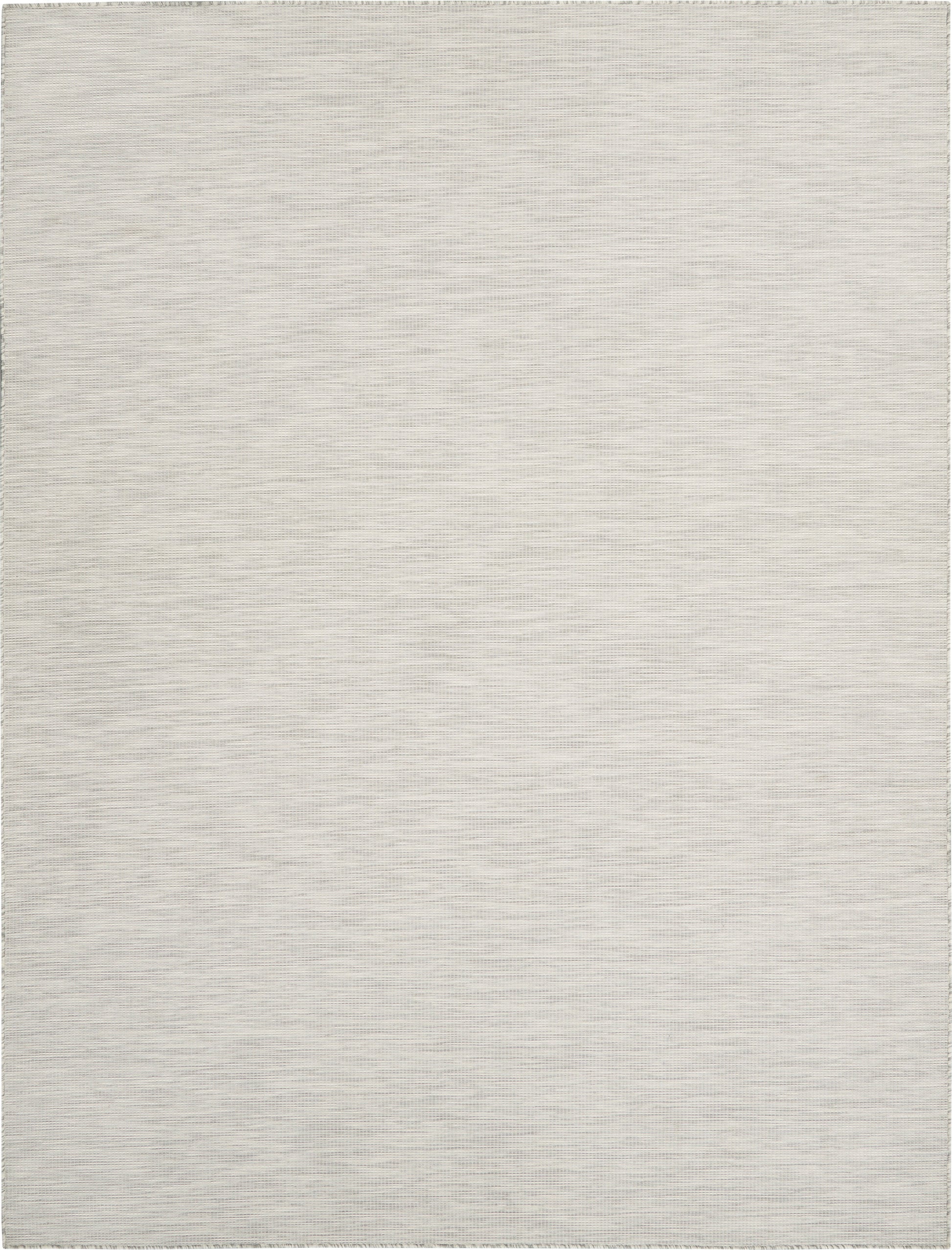Light gray woven area rug with subtle striped texture and short fringe along edges.